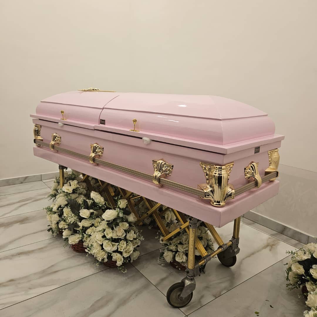 Pink sprayed dome casket with rose gold stationary accessories